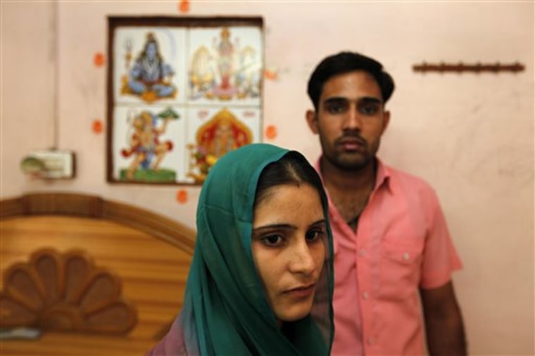 Ravinder Gehlaut and Shilpa Kadiyan sit in a relative's house in Sultanpur Dabas village on the outskirts of New Delhi, India, where the couple were forced to flee for their lives.